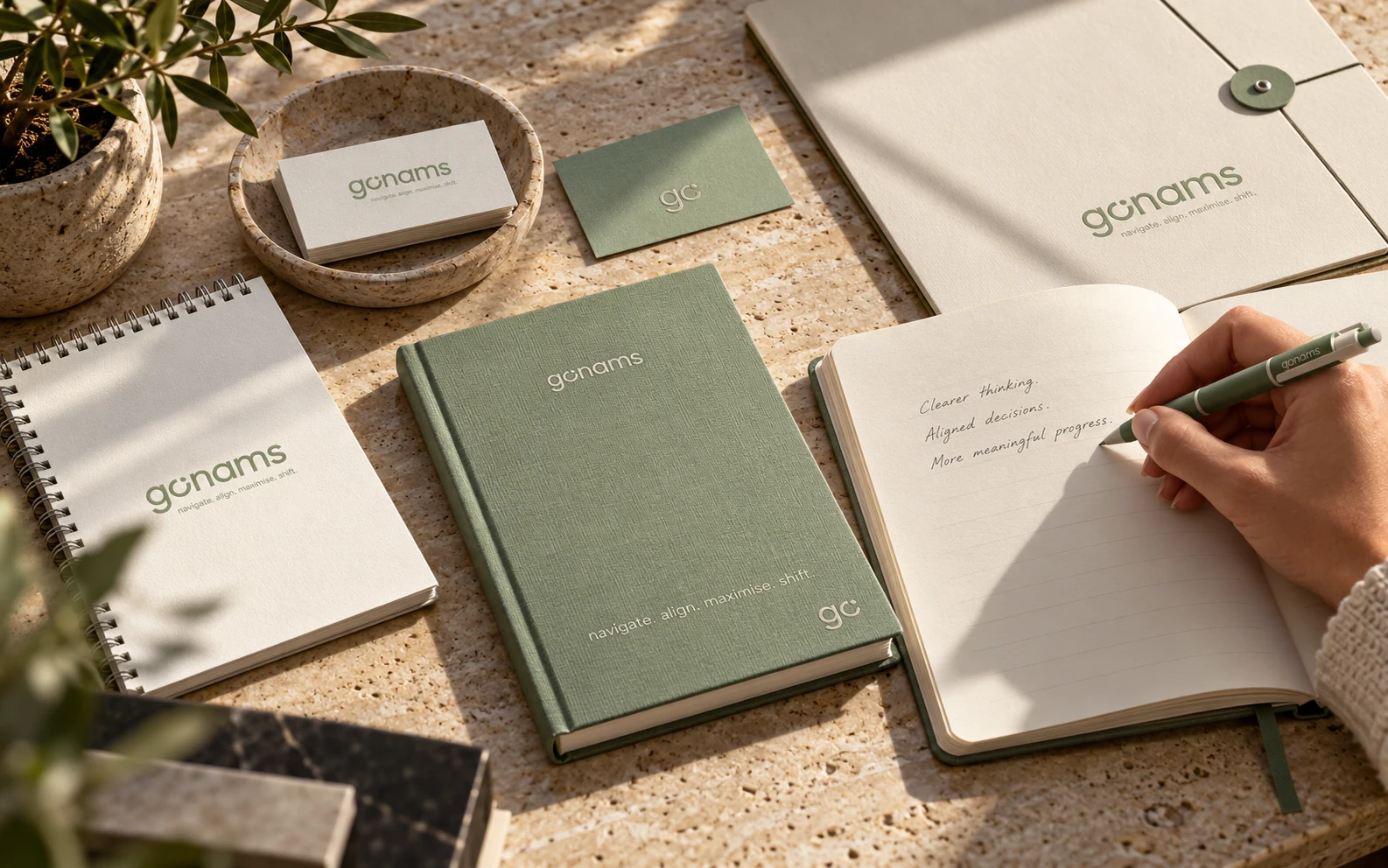 GONAMS stationery in active use on a warm stone desk